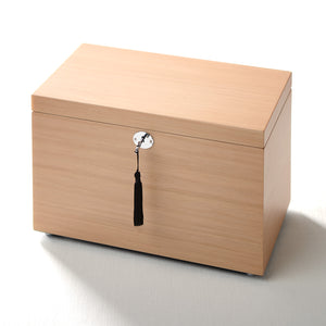 Wooden box with a lock and tassel on a white background