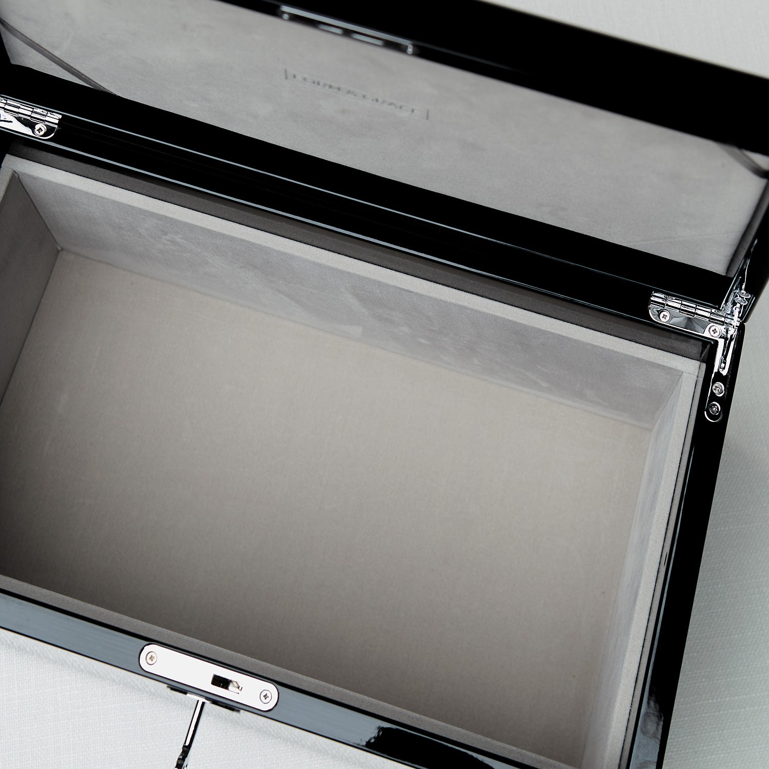 Open briefcase with a pen inside on a light gray background