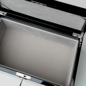 Open briefcase with a pen inside on a light gray background