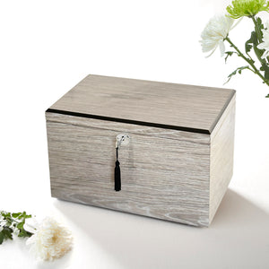 Wooden jewelry box with a key on a white background