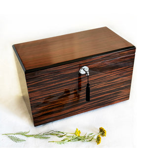 Wooden jewelry box with a decorative clasp on a white background